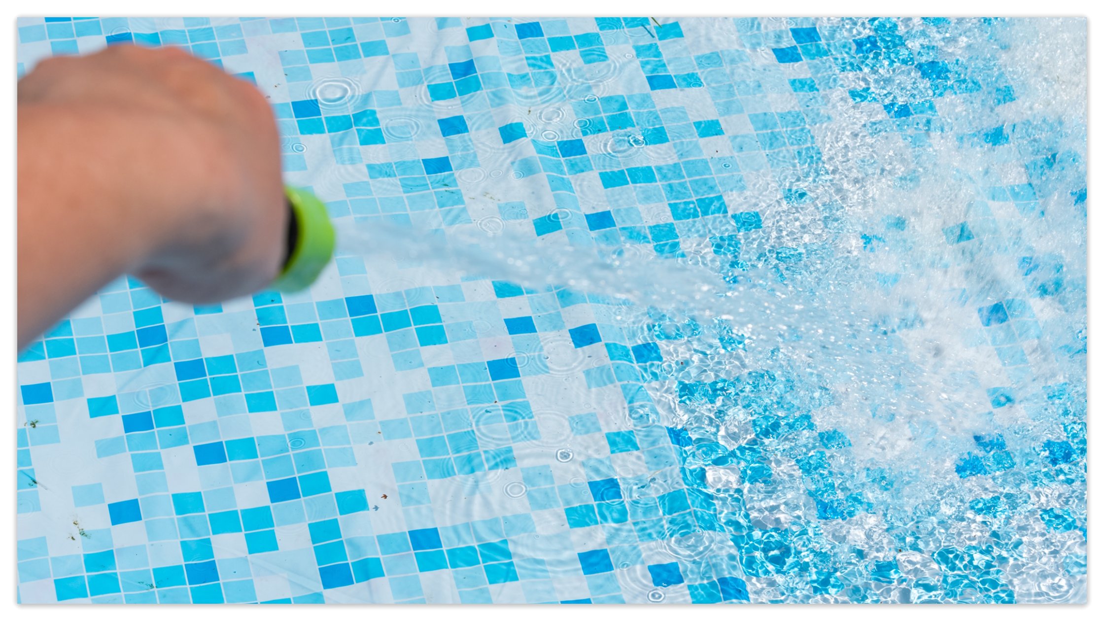 Garden hose splashing water into pool