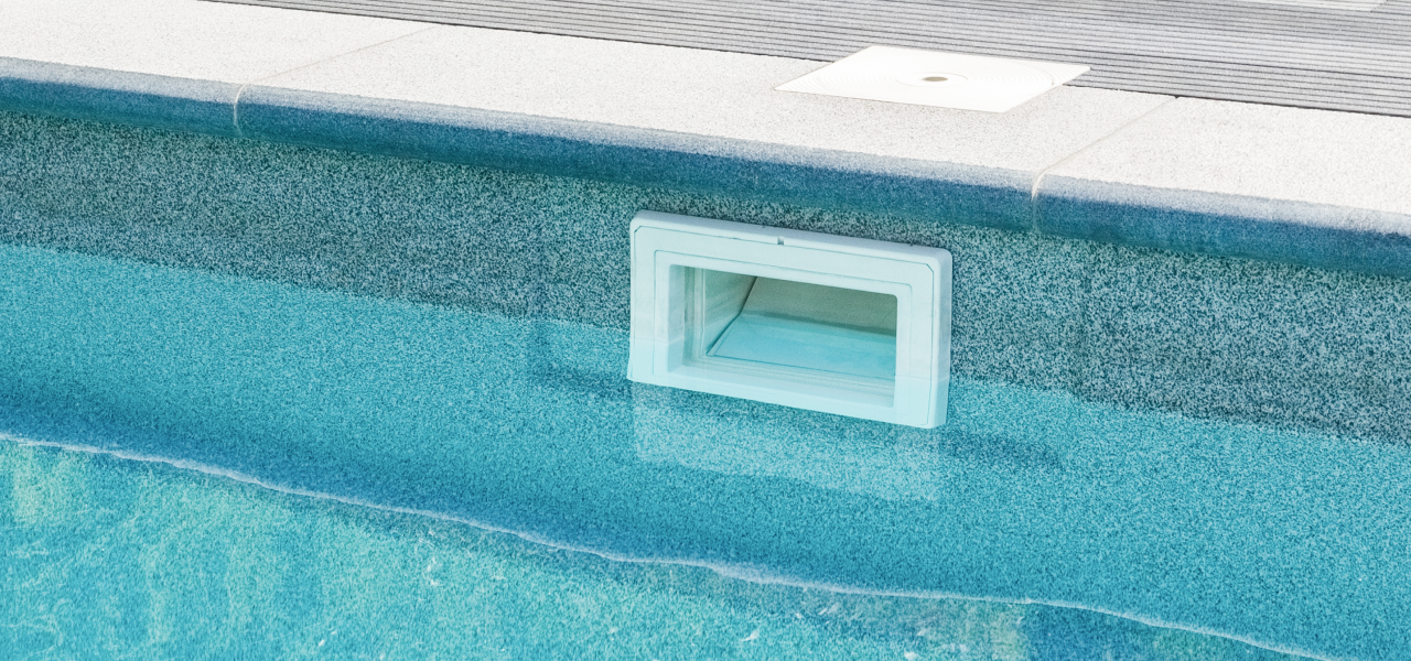Close-up of pool skimmer system highlighting importance of inspection and maintenance for winter pool protection.