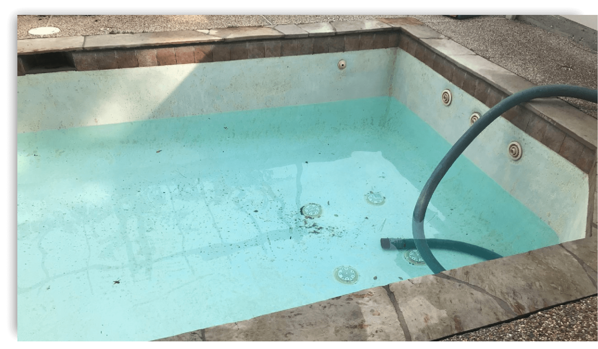 A partially drained swimming pool being refilled with a hose, which may require a council permit.