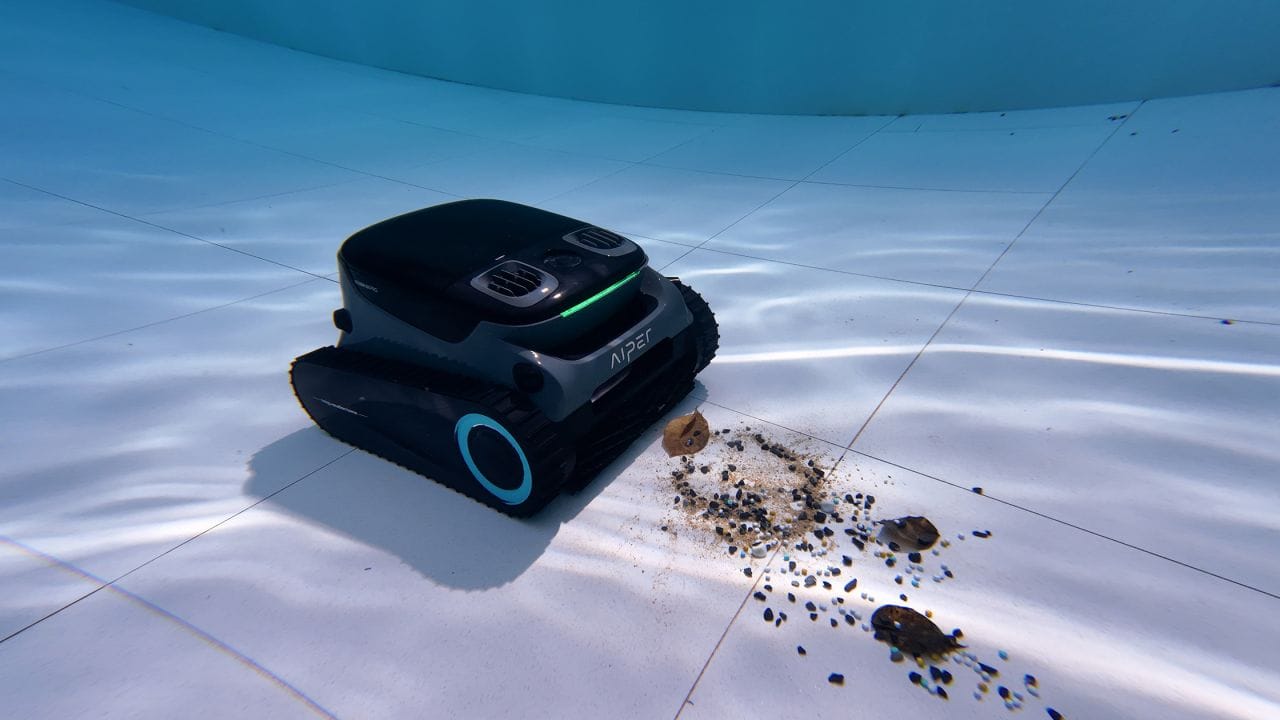A robotic pool cleaner vacuuming fine sediment and leaving a perfectly clear path on the pool floor.