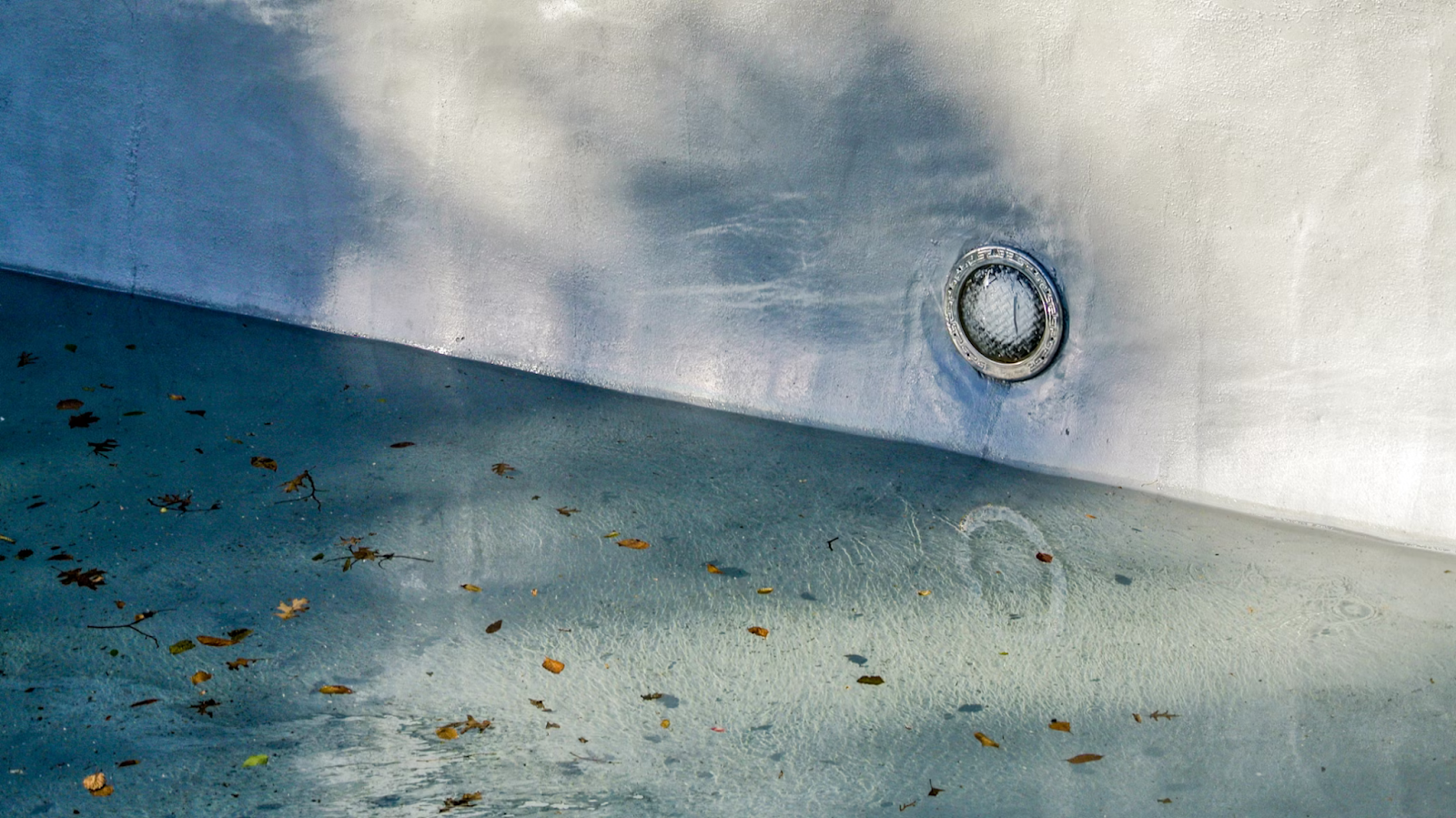 Blätter schwimmen auf dem Poolwasser