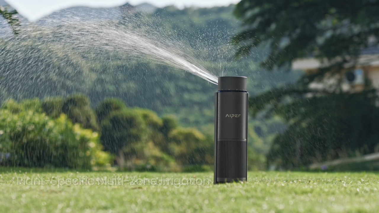 A sprinkler system watering the lawn during early morning sunrise to minimize evaporation.