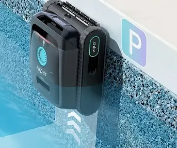 Aiper Scuba V3 robotic pool cleaner docked on Pebble Tec pool wall, featuring JetAssist waterline scrubbing for textured pool surfaces.