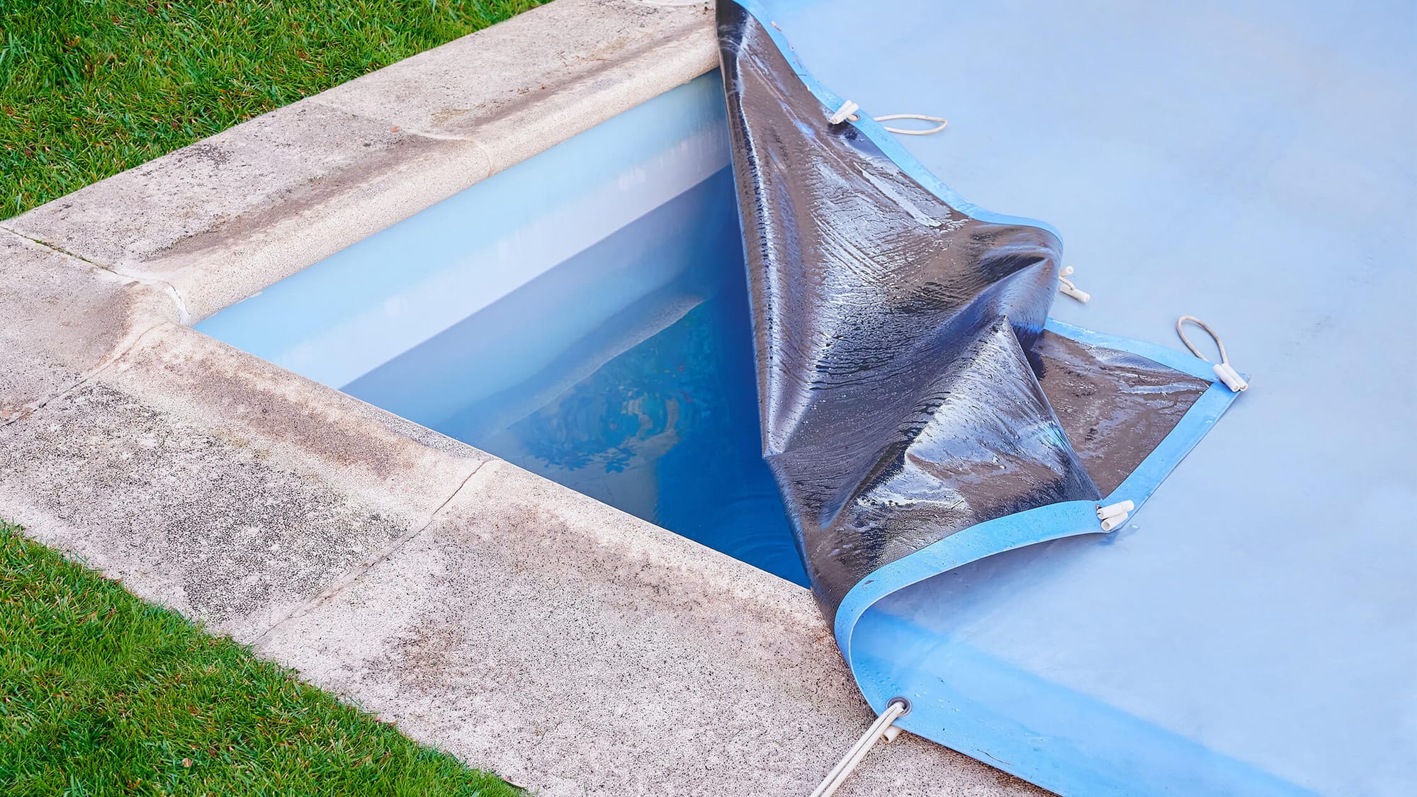 A corner of the swimming pool cover was lifted