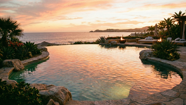 a beautiful, crystal-clear saltwater swimming pool at sunset with subtle ripples on the surface.