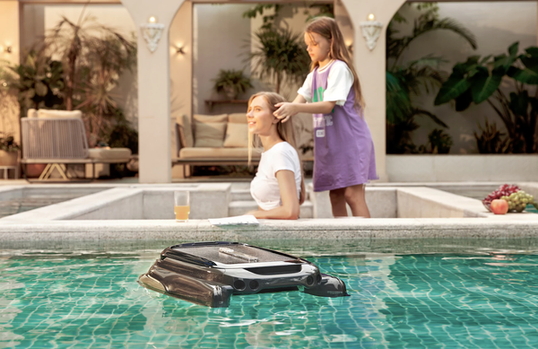 Above-ground pool skimmer working while mom and daughter bonds in the background