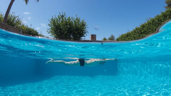 A swimmer enjoying the silky water of a converted magnesium mineral pool in a sunny backyard.